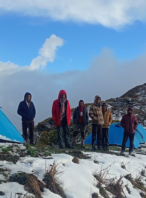 Professional trekking tents pitched at Chofu Top campsite under a clear starlit sky in the Kumaon Himalayas.