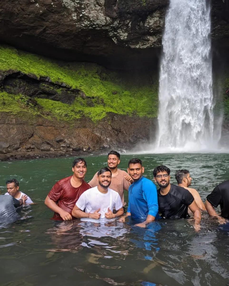 Trekkers enjoying the view at Devkund Waterfall Trek in Maharashtra